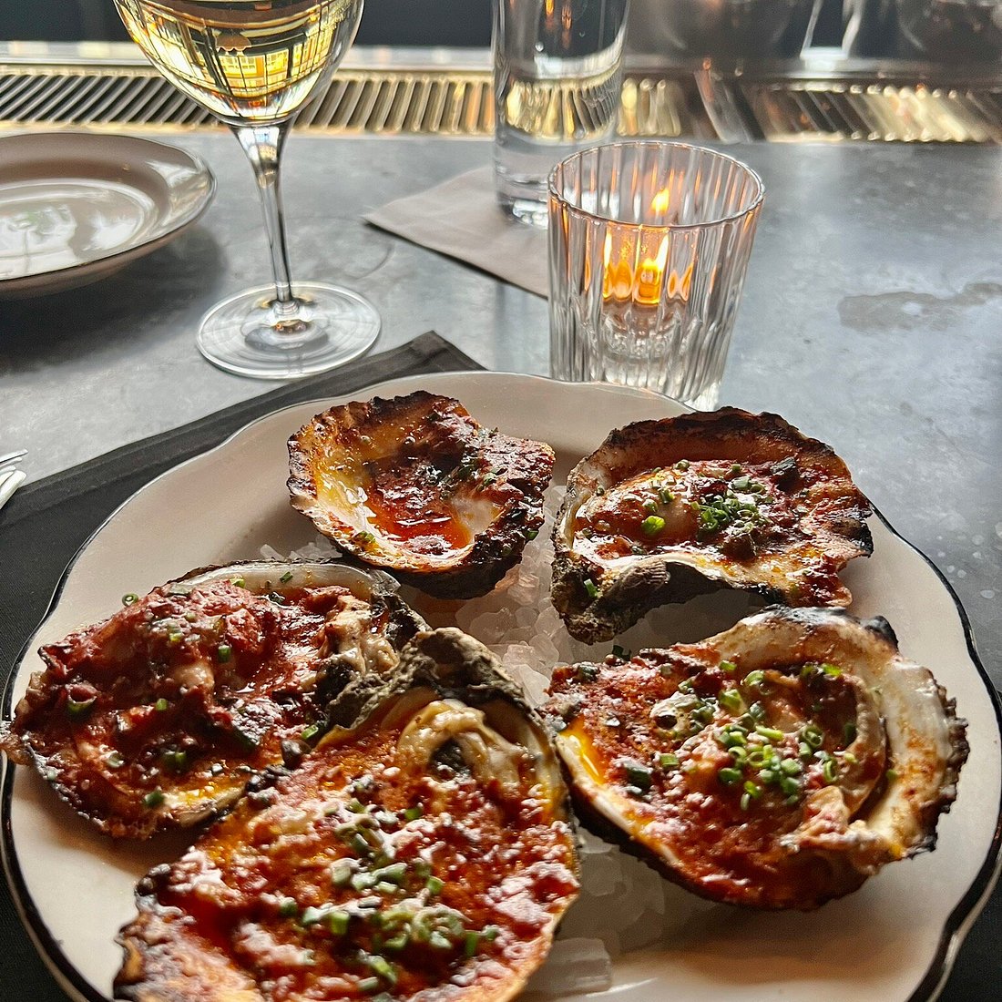 Automatic Seafood and Oysters signature dishes Menu changes daily based on fresh catches; expect items like various raw and baked oysters, wood-roasted fish, crudos, and seasonal seafood entrees.